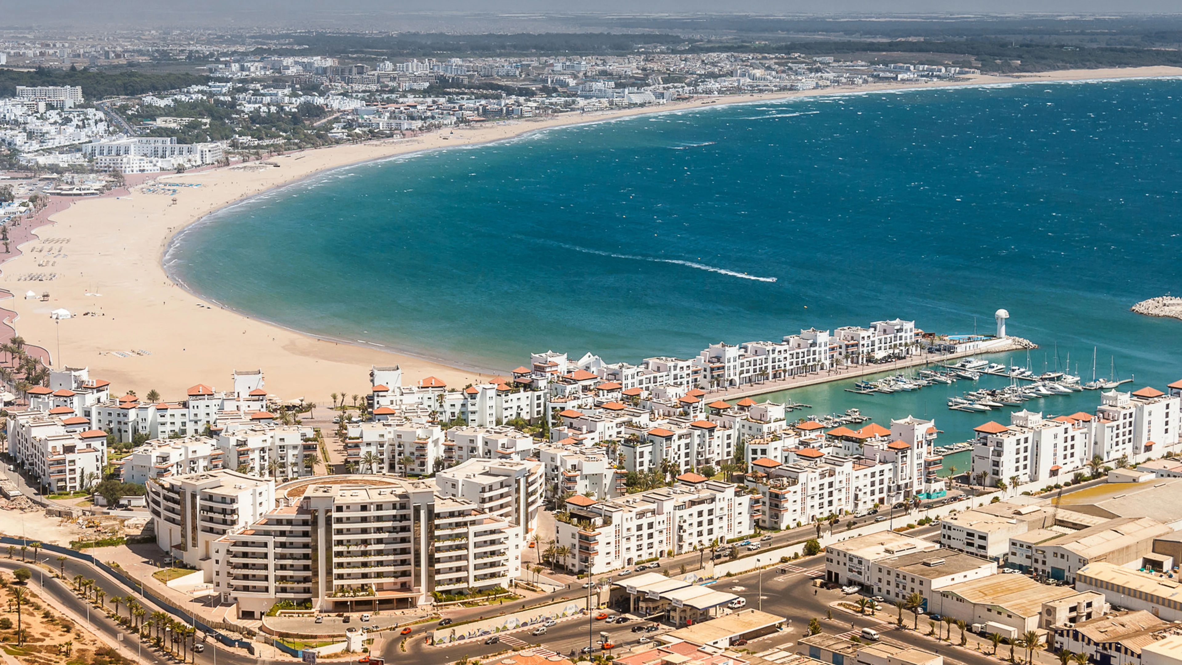Sweeping crescent beach and promenade of Agadir seen from the kasbah hill at sunset