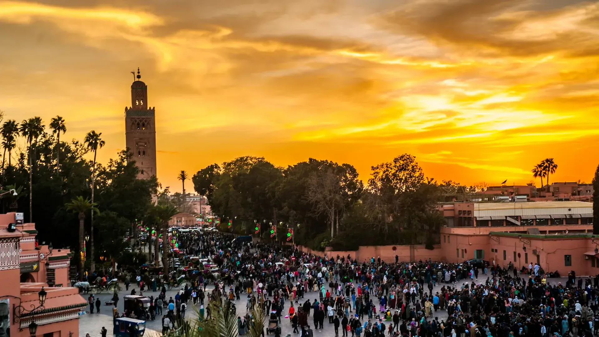 Lantern-lit food stalls and crowds at Jemaa el-Fnaa square in Marrakech at dusk